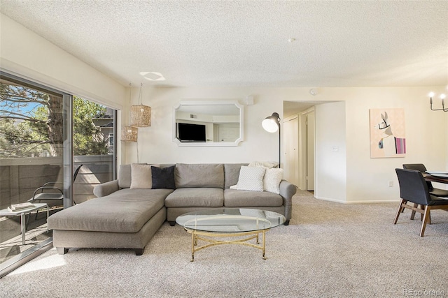 carpeted living room with a textured ceiling and a chandelier