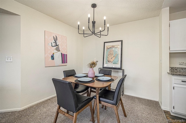 dining area featuring a chandelier, a textured ceiling, and dark carpet