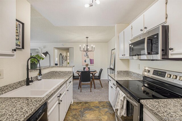 kitchen with white cabinets, sink, appliances with stainless steel finishes, and a chandelier