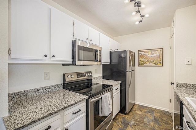 kitchen with light stone countertops, white cabinets, and stainless steel appliances