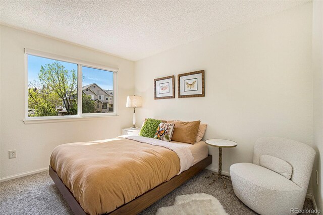 carpeted bedroom featuring a textured ceiling