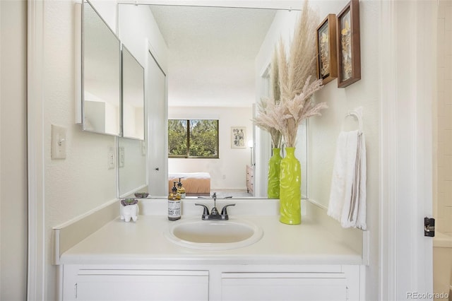 bathroom with vanity and a textured ceiling