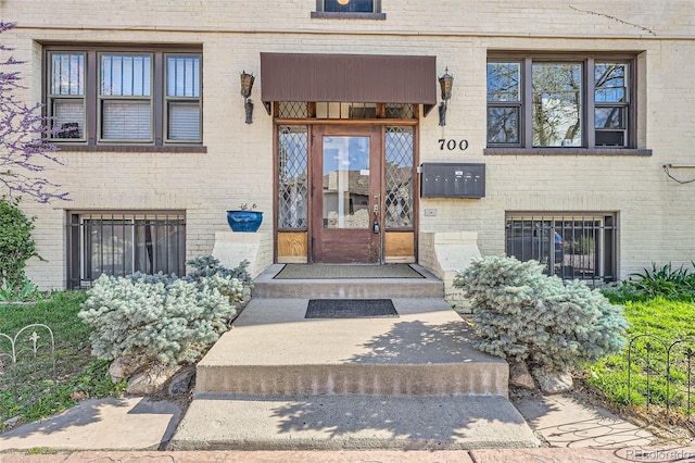 doorway to property featuring brick siding