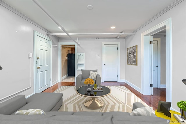 living area with wood finished floors, recessed lighting, baseboards, and ornamental molding