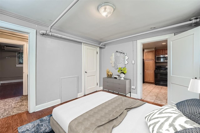 bedroom with baseboards and light wood-type flooring
