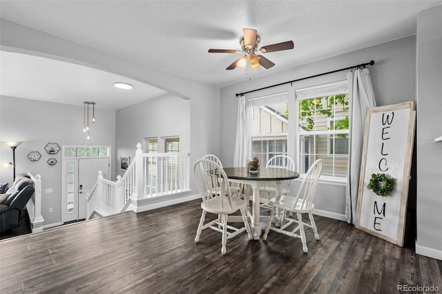 1464 Nemrick Pl, Castle Rock, CO 80109 - dining space featuring baseboards, wood finished floors, arched walkways, and ceiling fan