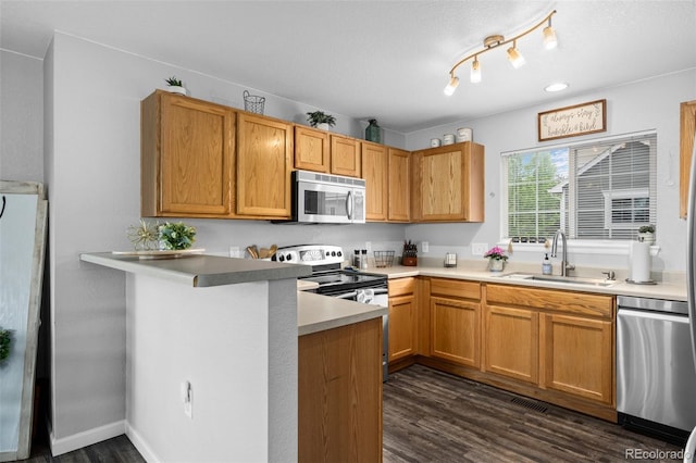 1464 Nemrick Pl, Castle Rock, CO 80109 - kitchen with a sink, stainless steel appliances, dark wood-style flooring, light countertops, and a peninsula