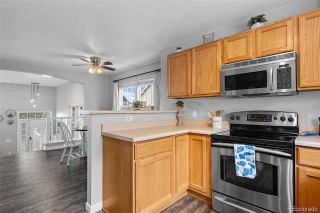 1464 Nemrick Pl, Castle Rock, CO 80109 - kitchen featuring appliances with stainless steel finishes, dark wood-style flooring, ceiling fan, a peninsula, and light countertops