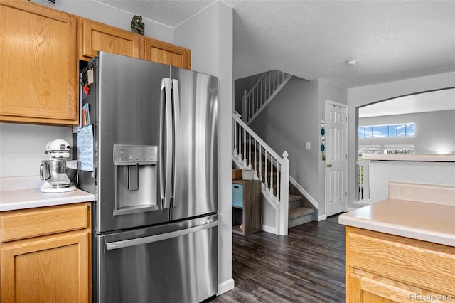 1464 Nemrick Pl, Castle Rock, CO 80109 - kitchen with stainless steel refrigerator with ice dispenser, dark wood-type flooring, a textured ceiling, light countertops, and arched walkways