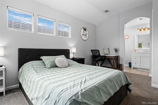 1464 Nemrick Pl, Castle Rock, CO 80109 - bedroom featuring arched walkways, light colored carpet, lofted ceiling, baseboards, and ensuite bath