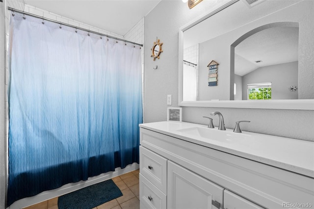 1464 Nemrick Pl, Castle Rock, CO 80109 - full bathroom with lofted ceiling, vanity, tile patterned floors, and a textured wall