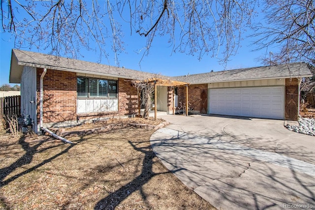 8895 E Radcliff Ave E, Denver, CO 80237 - ranch-style house featuring concrete driveway, brick siding, an attached garage, and fence