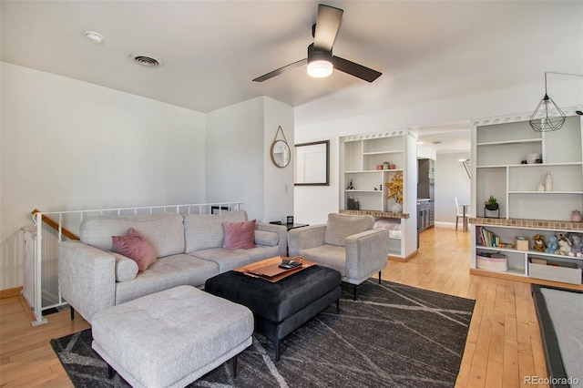 8895 E Radcliff Ave E, Denver, CO 80237 - living area featuring light wood-type flooring, baseboards, and a ceiling fan