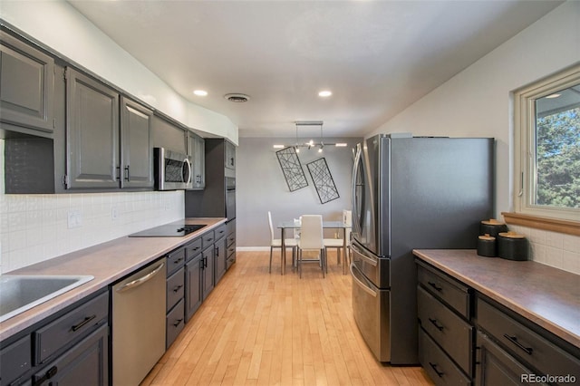 8895 E Radcliff Ave E, Denver, CO 80237 - kitchen with stainless steel appliances, backsplash, recessed lighting, light wood-style floors, and a sink