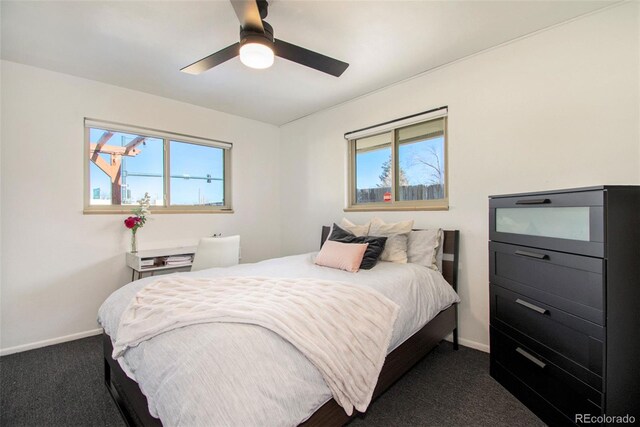 8895 E Radcliff Ave E, Denver, CO 80237 - bedroom with dark colored carpet, baseboards, multiple windows, and ceiling fan