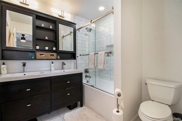 8895 E Radcliff Ave E, Denver, CO 80237 - bathroom featuring combined bath / shower with glass door, toilet, double vanity, and tile patterned flooring