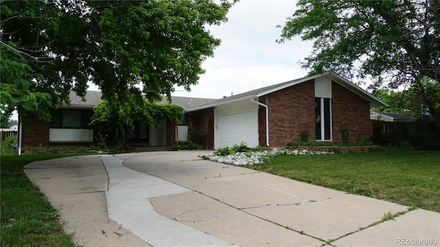 8895 E Radcliff Ave E, Denver, CO 80237 - ranch-style house featuring brick siding, an attached garage, driveway, and a front lawn