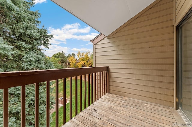 wooden terrace with a lawn