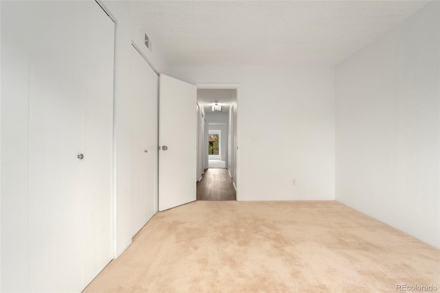 unfurnished room with light colored carpet