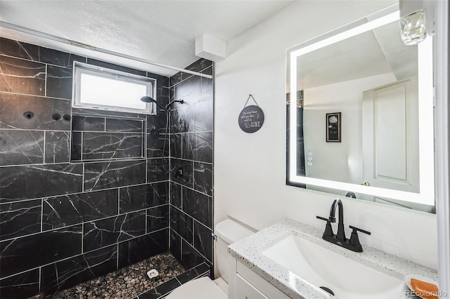 327 N 12th Ave, Brighton, CO 80601 - full bath featuring tiled shower, vanity, and a textured ceiling