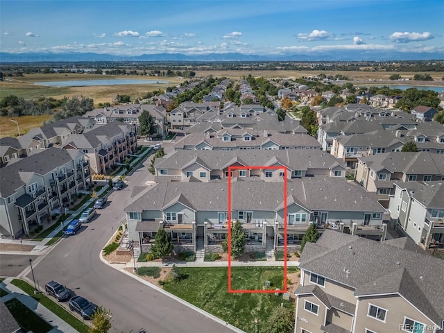 drone / aerial view with a water view and a residential view