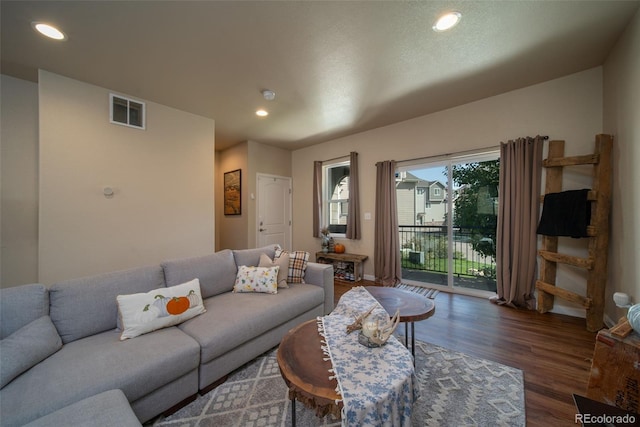 living room featuring visible vents, dark wood finished floors, and recessed lighting