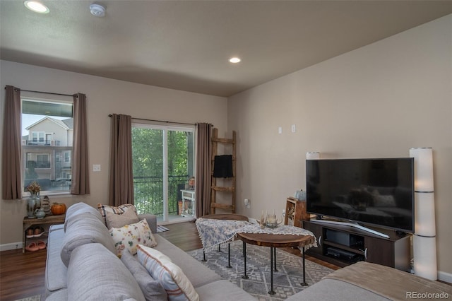 living area with recessed lighting, baseboards, and wood finished floors