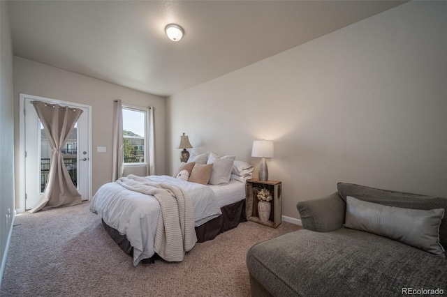 bedroom featuring light carpet and baseboards