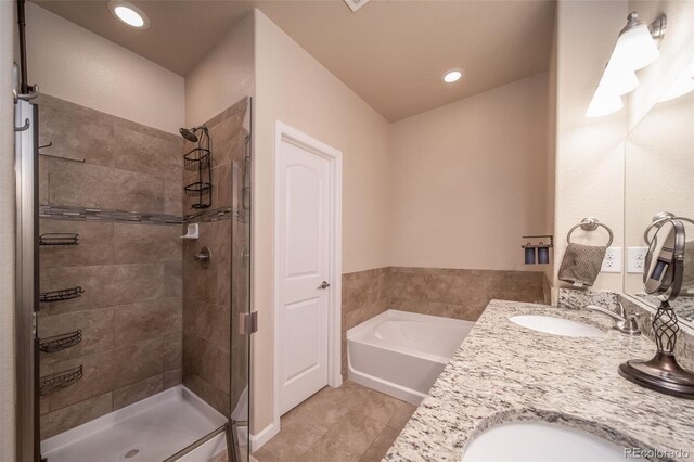 full bath with a garden tub, a sink, a shower stall, and double vanity