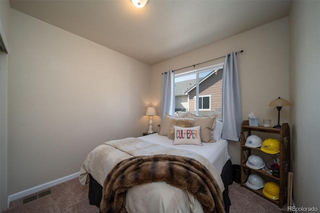 bedroom with carpet floors, visible vents, and baseboards