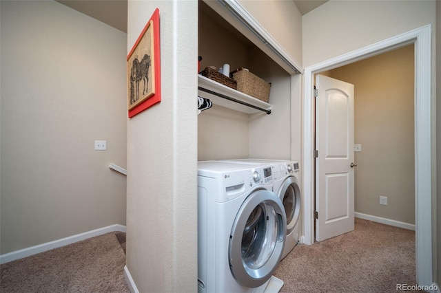 laundry room featuring washer and dryer, light carpet, and baseboards