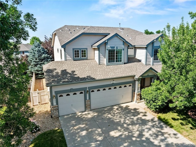 6808 Silverleaf Ave, Firestone, CO 80504 - view of front facade featuring roof with shingles, a garage, concrete driveway, and stone siding