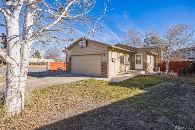 ranch-style home featuring a garage and a front lawn