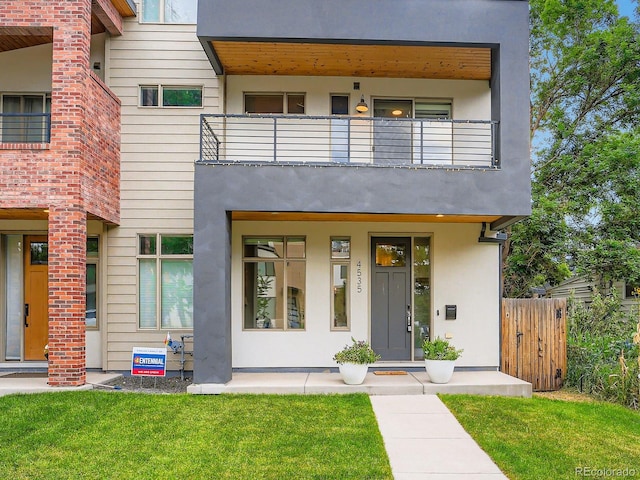 4535 Stuart St, Denver, CO 80212 - view of front facade with stucco siding and a balcony