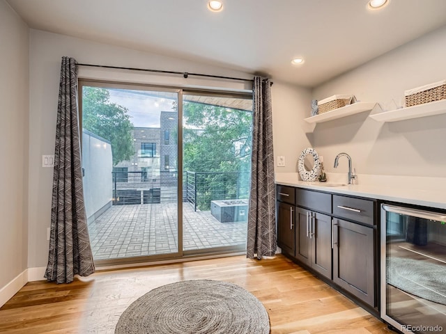 4535 Stuart St, Denver, CO 80212 - indoor wet bar with beverage cooler, light wood-type flooring, and recessed lighting