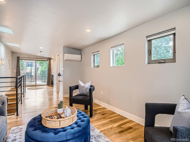 4535 Stuart St, Denver, CO 80212 - living room with an AC wall unit, light wood-type flooring, a skylight, and recessed lighting