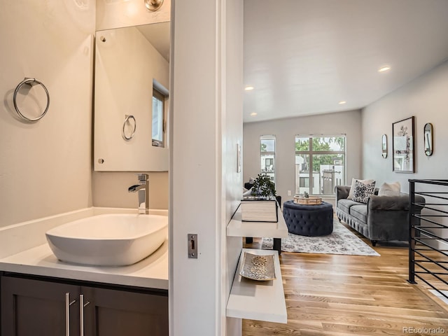 4535 Stuart St, Denver, CO 80212 - bathroom featuring wood finished floors, vanity, and recessed lighting