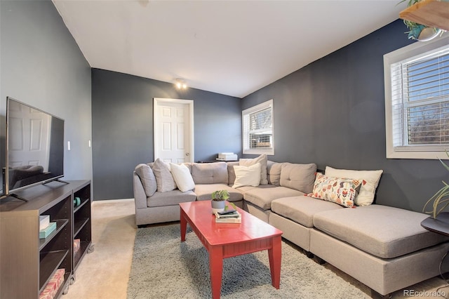 living area featuring lofted ceiling and light colored carpet