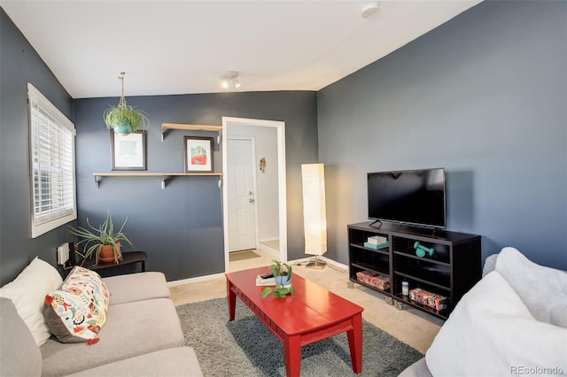 living room with baseboards, lofted ceiling, and carpet flooring