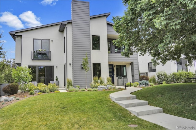 3450 S Cherry St, Denver, CO 80222 - view of front of property featuring a front yard, a chimney, a balcony, and stucco siding
