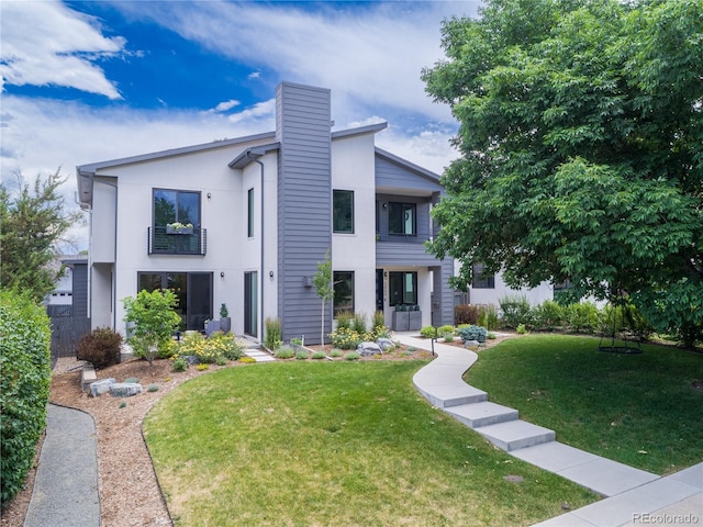 3450 S Cherry St, Denver, CO 80222 - view of front of property featuring a chimney, a front yard, and stucco siding