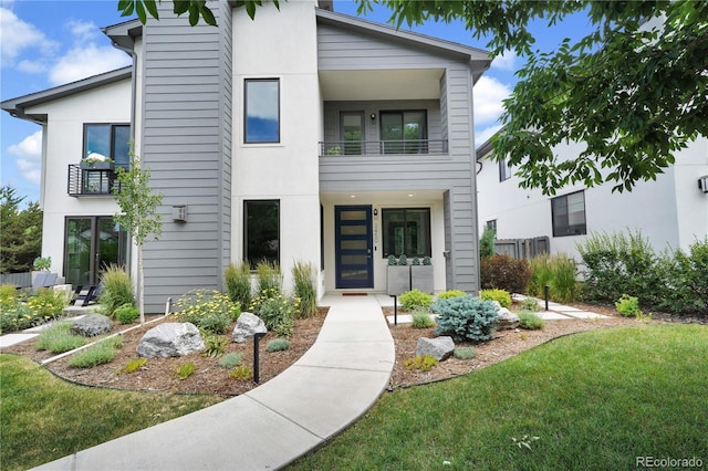 3450 S Cherry St, Denver, CO 80222 - view of front facade featuring a balcony and a front yard