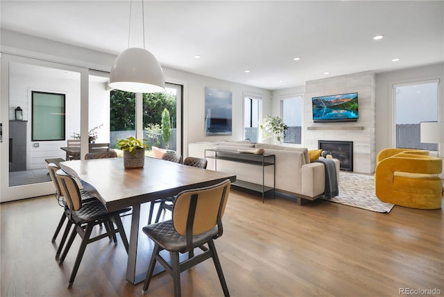 3450 S Cherry St, Denver, CO 80222 - dining area with wood finished floors, a tiled fireplace, and recessed lighting