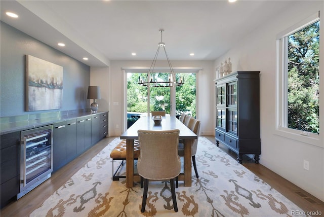 3450 S Cherry St, Denver, CO 80222 - dining space with wine cooler, a chandelier, recessed lighting, and light wood-type flooring