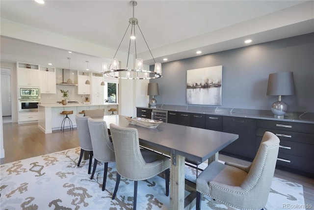 3450 S Cherry St, Denver, CO 80222 - dining space with wood finished floors, recessed lighting, a chandelier, and wine cooler