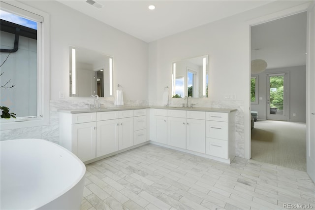 3450 S Cherry St, Denver, CO 80222 - bathroom with double vanity, a freestanding bath, and recessed lighting