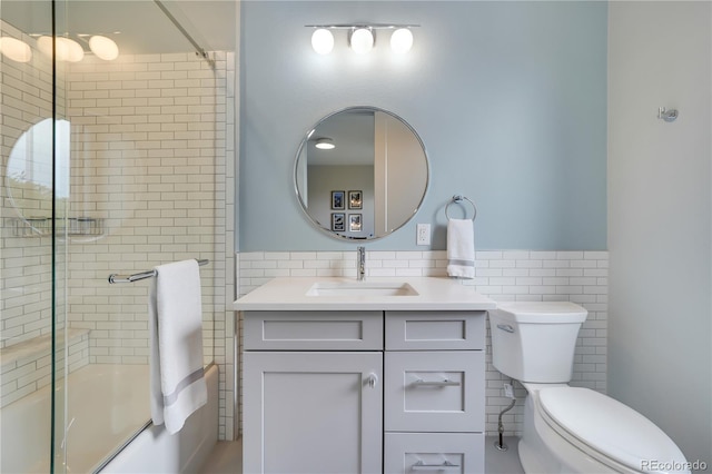 3450 S Cherry St, Denver, CO 80222 - full bathroom featuring tile walls, vanity, enclosed tub / shower combo, and a wainscoted wall