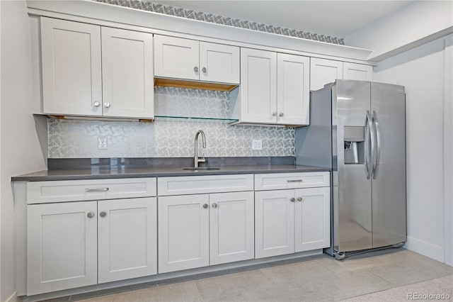 3450 S Cherry St, Denver, CO 80222 - kitchen featuring stainless steel fridge, dark countertops, and tasteful backsplash