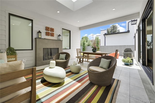 3450 S Cherry St, Denver, CO 80222 - living room with a fireplace, tile patterned flooring, recessed lighting, a skylight, and wooden walls