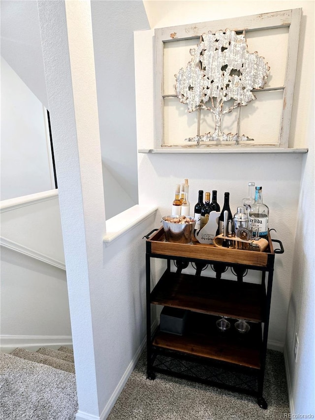 bar featuring carpet and baseboards